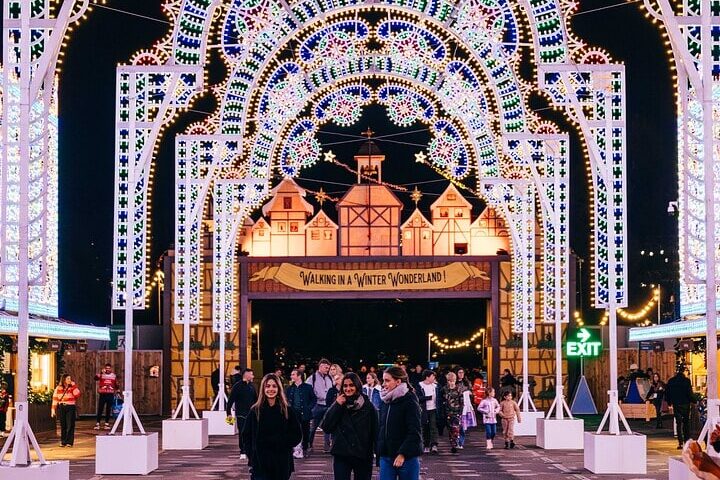 group of women walking through luminaries lights at Winter Wonderland